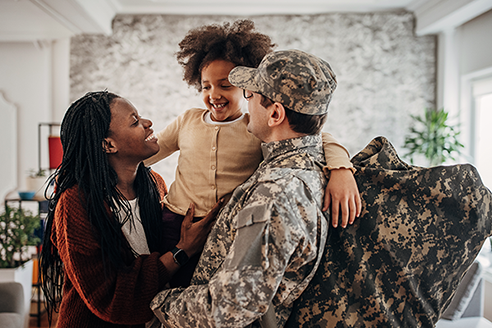 Two parents holding a young child. 